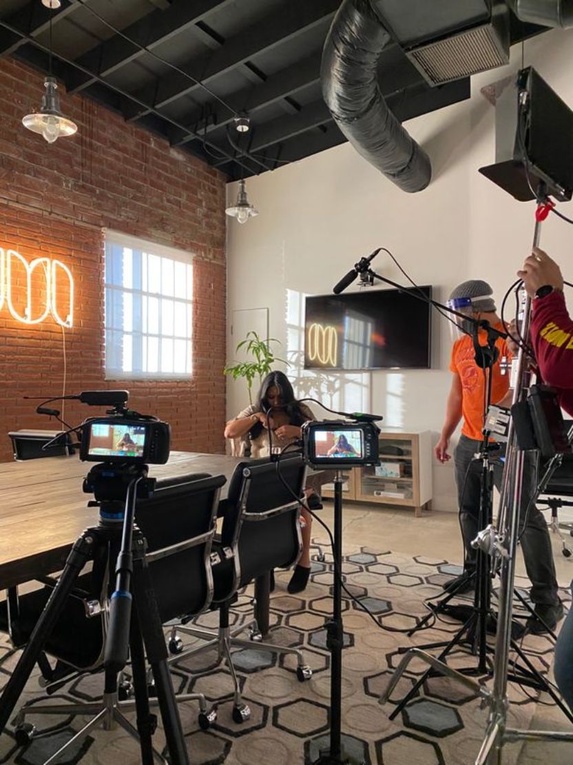 Behind-the-scenes production setup with cameras and crew in a studio